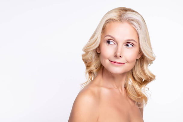 Portrait of attractive curious healthy grey-haired woman looking aside copy blank space healthcare isolated over white color background - Foto, immagini
