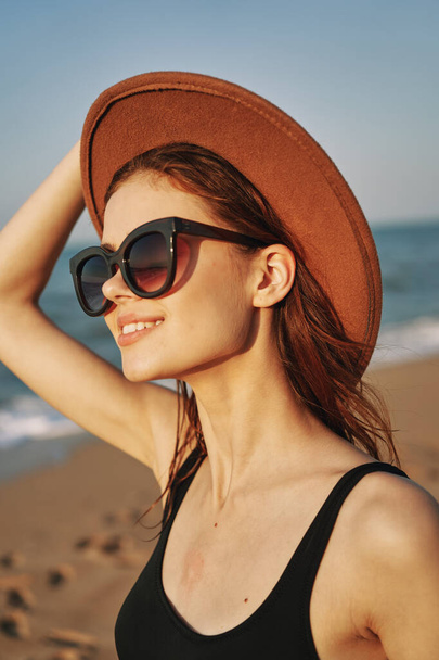 cheerful woman in sunglasses Sandy coast landscape sun - Fotó, kép