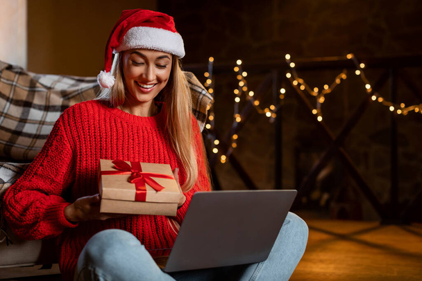 Happy Woman Holding Present Boxes Using Laptop, Video-Calling With Relatives - Photo, Image