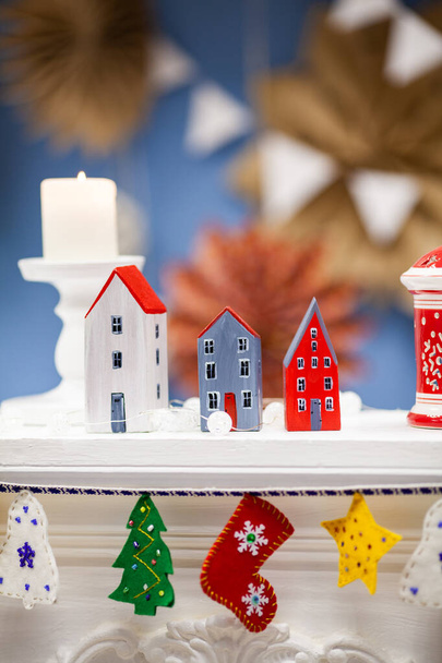 small, painted wooden houses. Handmade. Beautiful New Year's decor for the home. A Christmas gift - Фото, изображение