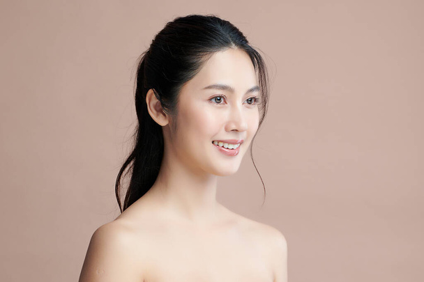 Beautiful young asian woman with clean fresh skin on beige background, Face care, Facial treatment, Cosmetology, beauty and spa, Asian women portrait. - Zdjęcie, obraz