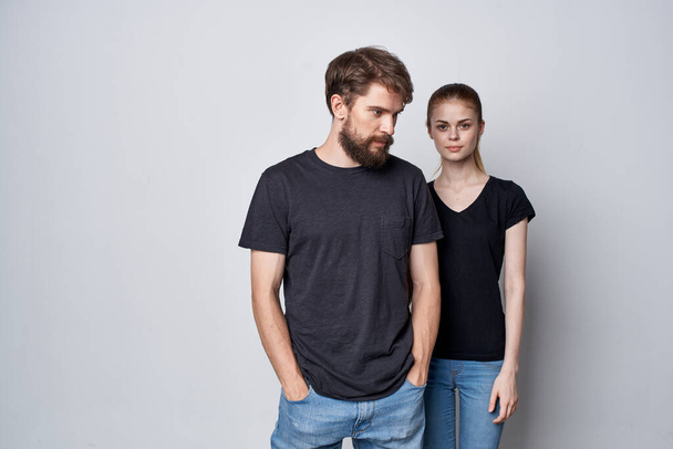 fashionable man and woman socializing together posing fashion light background - Photo, Image