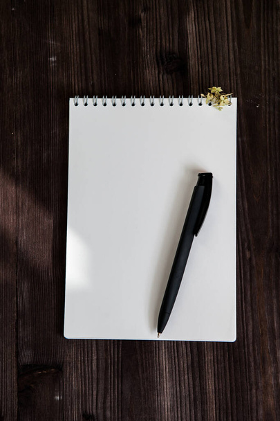  open white notebook on a dark wooden background    - Фото, изображение