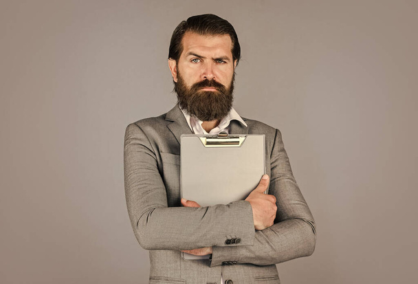 Ready for sale. Pleasant cheerful handsome realtor holding folder. bearded man working in office. Portrait of successful businessman dressed in formal clothes. serious boss with document - Φωτογραφία, εικόνα