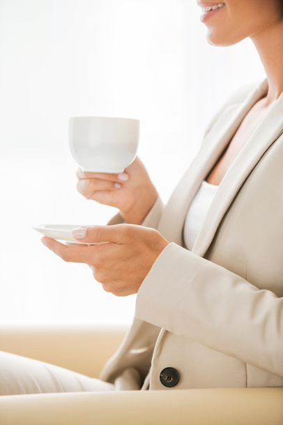 Businesswoman in suit drinking coffee - Foto, Imagen