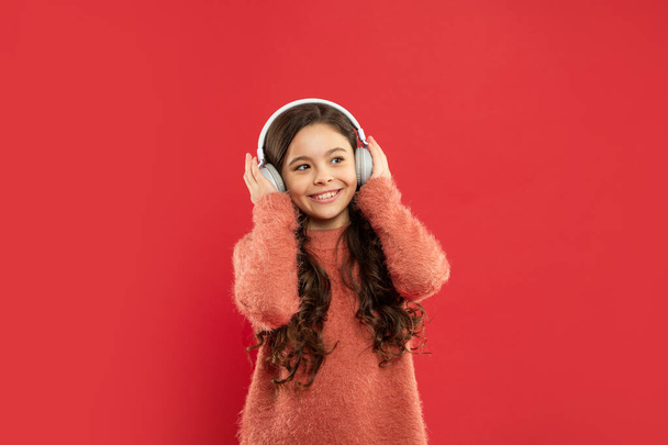 cheerful teen girl in earphones. modern life in childhood. listening audio book. - Photo, Image