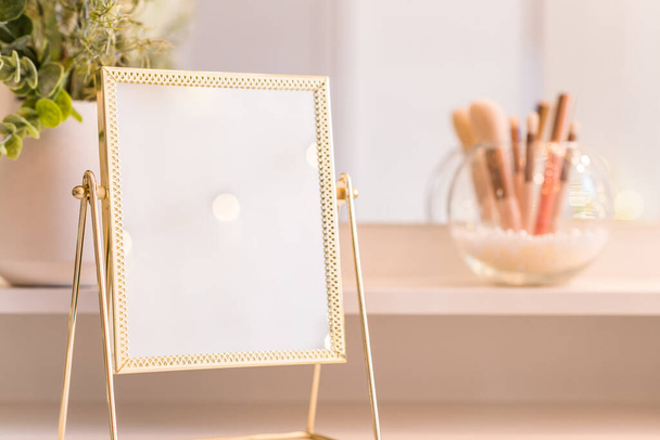 Table mirror on dressing table with make up accessories. Self-Care. White, pastel interior - Fotoğraf, Görsel