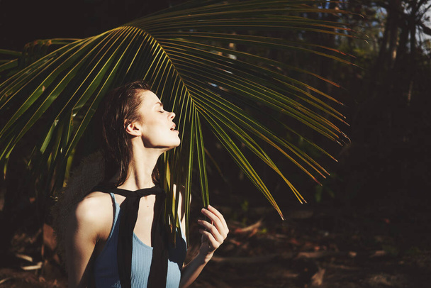 woman in swimwear palm leaf jungle island beach sun - Valokuva, kuva