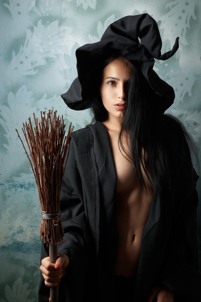sexy girl in witch costume with a broom - Foto, immagini