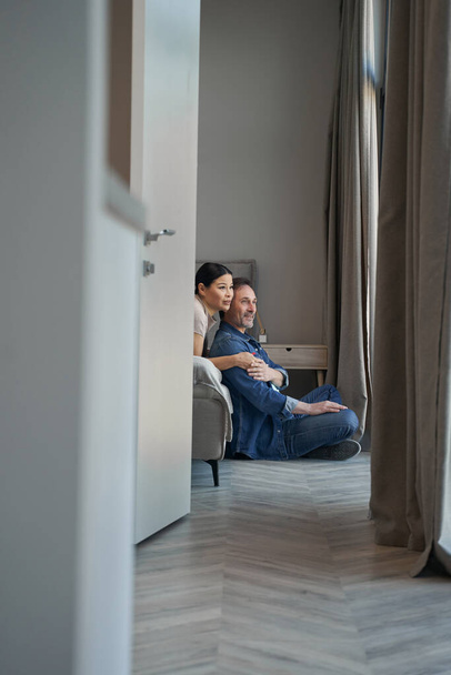Happy aged couple during romantic day indoors - Photo, Image