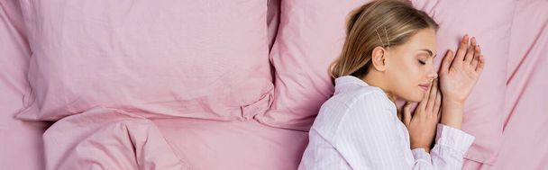 Top view of pretty woman in pajamas sleeping on bed, banner  - Photo, image