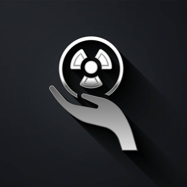 Silver Radioactive in hand icon isolated on black background. Radioactive toxic symbol. Radiation Hazard sign. Long shadow style. Vector - Vecteur, image