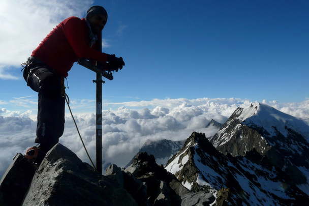 Climber posing at Lagginhorn mountain's summit in the Alps, Switzerland - Photo, Image