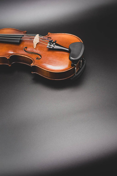 top view of elegant acoustic violin on a dark background with copy space - Fotó, kép
