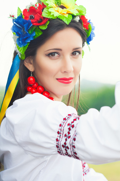 Woman wearing national ukrainian clothes outdoors - 写真・画像