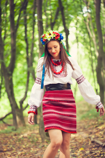 Woman wearing national ukrainian clothes posing in forest - Φωτογραφία, εικόνα