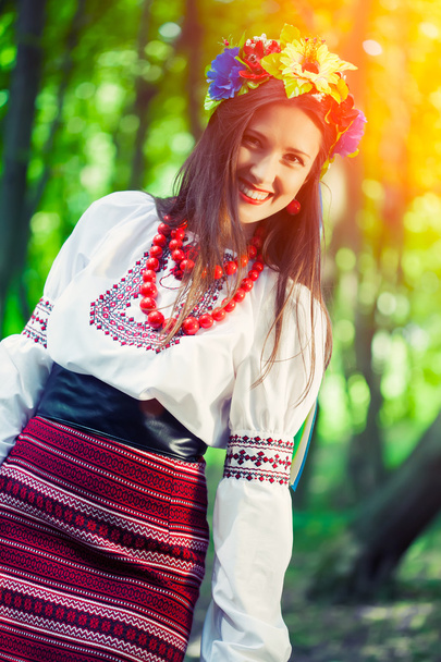 Woman wearing national ukrainian clothes posing in forest - Φωτογραφία, εικόνα
