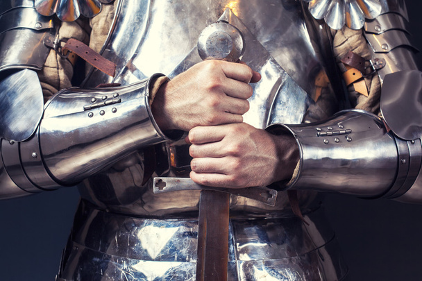 Knight wearing armor and holding sword - Fotoğraf, Görsel
