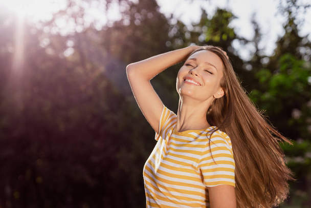 Portrait of attractive carefree cheerful dreamy peaceful girl spending holiday free time posing breathing fresh air outdoors - Foto, Bild