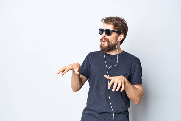 Cheerful man headphones sunglasses music dance fun light background - Fotografie, Obrázek