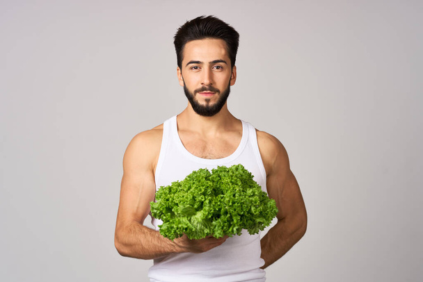 cheerful man in a white t-shirt lettuce leaves healthy food - Foto, imagen