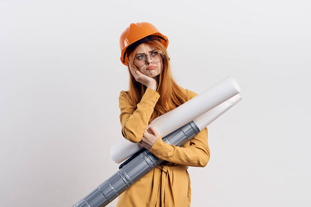 female engineer in orange hard hat blueprints architect - Foto, imagen