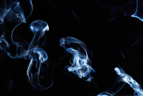 smoke on black background with abstract blur motion wave swirl . Wisp of Smoke. Cigarette smoke waves and clouds  texture - Fotoğraf, Görsel