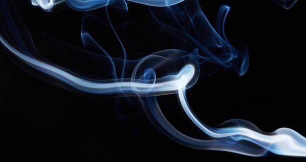 smoke on black background with abstract blur motion wave swirl . Wisp of Smoke. Cigarette smoke waves and clouds  texture - Foto, Bild