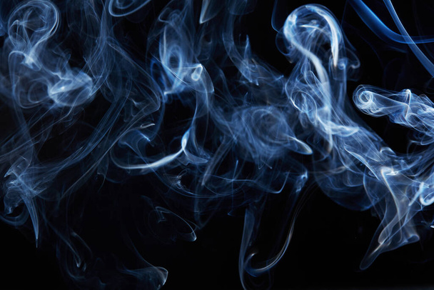 blue smoke on black background with abstract blur motion wave swirl . Wisp of Smoke. Cigarette smoke waves and clouds  texture - Foto, Imagen