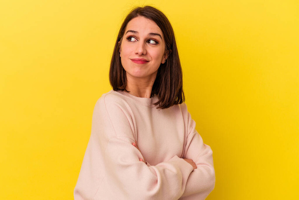 Young caucasian woman isolated on yellow background dreaming of achieving goals and purposes - Photo, Image