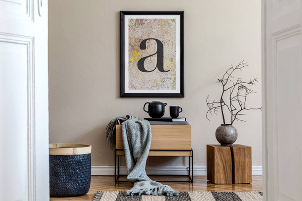 Modern scandinavian living room interior with black mock up poster frame, design commode, dried flower in vase, black rattan basket, books and elegant accessories. Template.  - 写真・画像