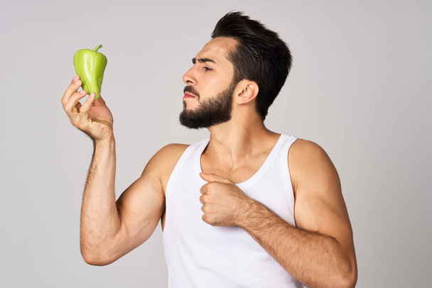 bearded man green pepper snack healthy food emotions - Φωτογραφία, εικόνα