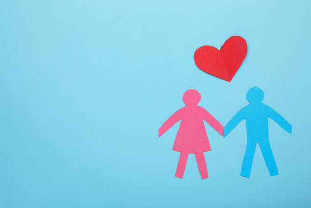 Paper family and heart on blue background. Love and family concept. Top view - Fotografie, Obrázek