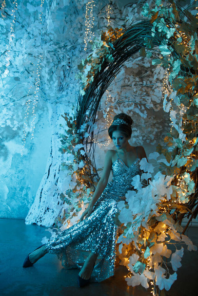 A woman in the form of a snow queen in a fairy-tale setting in mystical blue lighting .. - Foto, Imagem