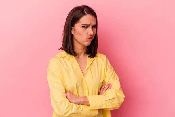 Young caucasian woman isolated on pink background unhappy looking in camera with sarcastic expression. - Photo, Image