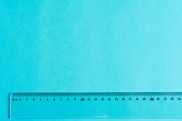 Plastic ruler on blue background with copy space. - Zdjęcie, obraz