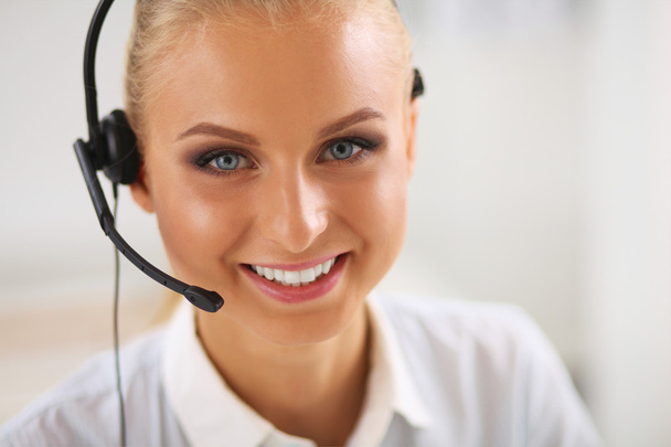 Close-up portrait of a customer service agent sitting at office - Photo, Image