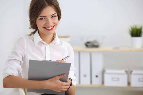 Portrait of a young woman working at office - Foto, imagen