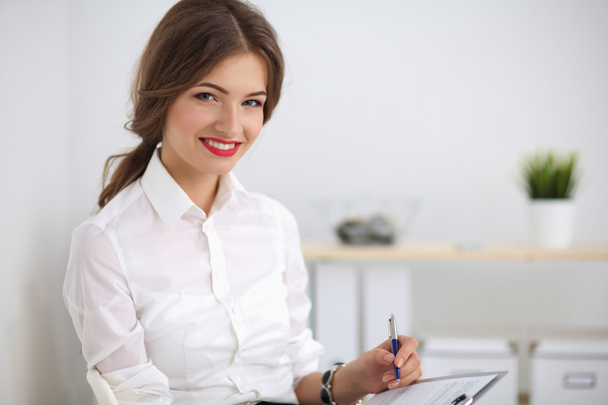Portrait of a young woman working at office - Photo, image