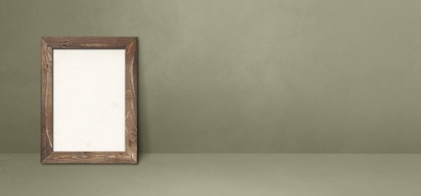 Wooden picture frame leaning on a grey wall. Blank mockup template. Horizontal banner - Foto, Imagen