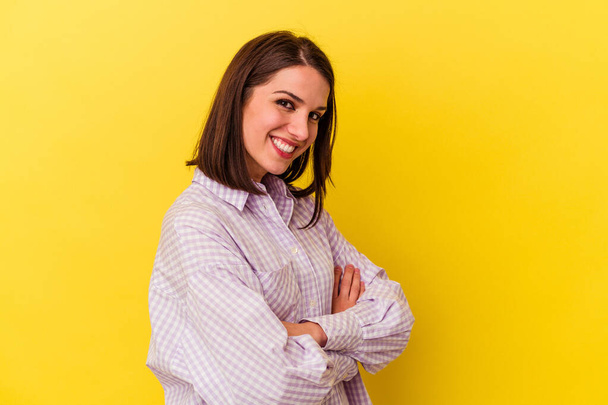 Young caucasian woman isolated on yellow background laughing and having fun. - Zdjęcie, obraz