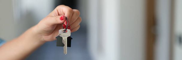 Female hand holds key to apartment closeup - Foto, Imagen