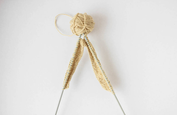Top view beige yarn and knitting needles on a white background isolated - Photo, Image