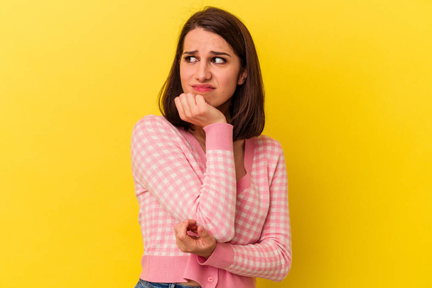 Young caucasian woman isolated on yellow background biting fingernails, nervous and very anxious. - Photo, Image