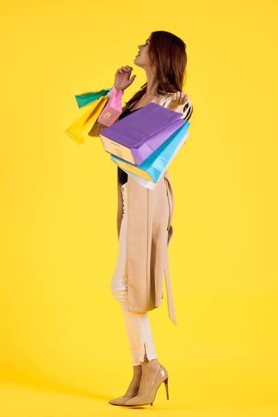 cheerful woman with packages in hands Shopaholic studio model - Фото, зображення