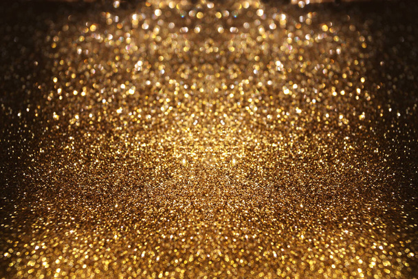Golden glitter shimmer on black background - Photo, Image