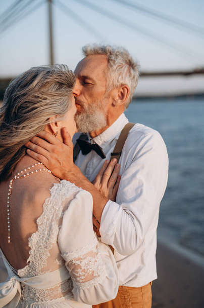 Senior newlyweds hug. - Fotoğraf, Görsel