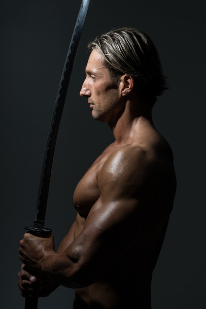 Mature Man Holding Sword Ready To Fight - Фото, зображення