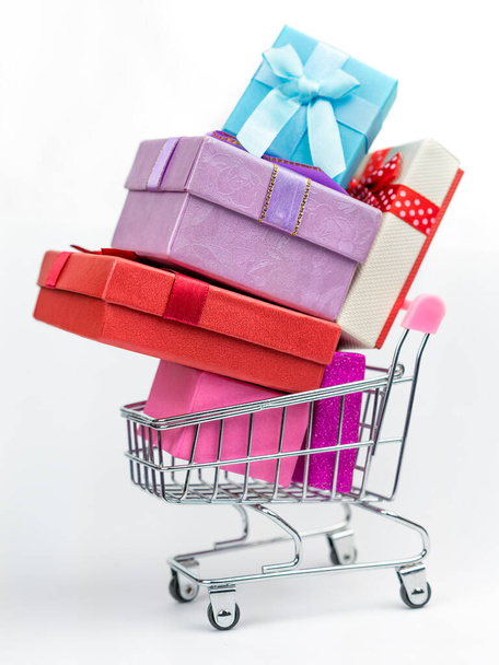 Colorful wrapped boxes in a trolley cart. Annual sale shopping season concept - Фото, зображення
