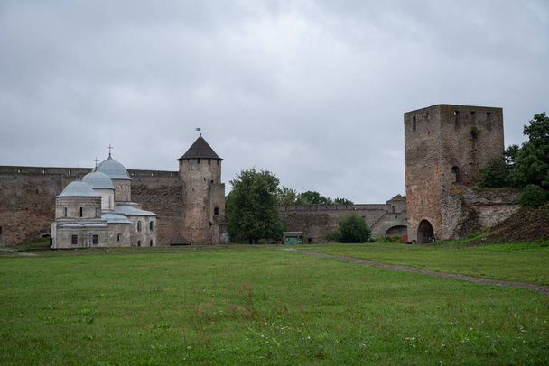 Courtyard of Ivangorod Fortress. View to churches of Saint Nicholas and Dormition of the Mother of God, walls and towers. Ivangorod, Russia - Photo, Image